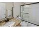 Bathroom featuring a granite vanity and shower with glass doors at 7758 E Nestling Way, Scottsdale, AZ 85255
