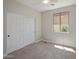 Cozy bedroom with soft carpet, neutral walls, a window with a view, and a closet at 7758 E Nestling Way, Scottsdale, AZ 85255