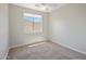 Minimalist bedroom with neutral carpeting and a sunny window view at 7758 E Nestling Way, Scottsdale, AZ 85255