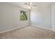Cozy bedroom with neutral carpeting and a green backyard view at 7758 E Nestling Way, Scottsdale, AZ 85255