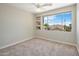 Bedroom featuring a bright window, neutral walls, and carpeted floors at 7758 E Nestling Way, Scottsdale, AZ 85255