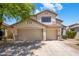 Charming two-story home featuring a well-manicured front yard, desert landscaping, and a three-car garage at 7758 E Nestling Way, Scottsdale, AZ 85255