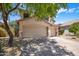 Charming two-story home featuring a well-manicured front yard, and a three-car garage with desert landscaping at 7758 E Nestling Way, Scottsdale, AZ 85255