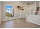 Grand foyer featuring soaring ceilings, large window, tile floors, and staircase to the second floor at 7758 E Nestling Way, Scottsdale, AZ 85255