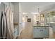 Modern kitchen featuring an island, stainless steel appliances, granite counters, and ample cabinet space at 7758 E Nestling Way, Scottsdale, AZ 85255