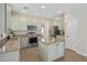 Well-lit kitchen with granite countertops, stainless steel appliances, and a center island at 7758 E Nestling Way, Scottsdale, AZ 85255