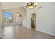 Open-concept living room featuring tile floors, a fireplace, and seamless access to the kitchen and foyer at 7758 E Nestling Way, Scottsdale, AZ 85255