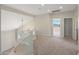Open loft area with carpet, neutral-toned walls, and plenty of natural light at 7758 E Nestling Way, Scottsdale, AZ 85255