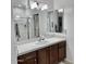 This bathroom showcases a sink with a beautiful white counter top with a shower/tub combination at 7925 S 52Nd Dr, Laveen, AZ 85339