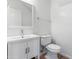 This bathroom features a white sink vanity, toilet, and mirror at 7925 S 52Nd Dr, Laveen, AZ 85339
