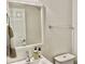 Cozy bathroom featuring a white vanity, patterned walls, and neutral-toned decor with a large mirror at 7925 S 52Nd Dr, Laveen, AZ 85339