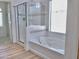 Bright bathroom featuring a glass-enclosed shower, soaking tub, and tiled accents at 7925 S 52Nd Dr, Laveen, AZ 85339