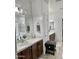 This bathroom showcases double sinks, warm-toned cabinets, a tub and a glass-enclosed shower at 7925 S 52Nd Dr, Laveen, AZ 85339