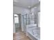 Bright bathroom featuring a glass-enclosed shower, soaking tub, and tiled accents at 7925 S 52Nd Dr, Laveen, AZ 85339