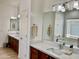 Bright bathroom features a long granite vanity, a large mirror, and a bath at 7925 S 52Nd Dr, Laveen, AZ 85339