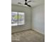 Bedroom with a ceiling fan and window view of the backyard at 7925 S 52Nd Dr, Laveen, AZ 85339