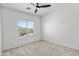 Neutral bedroom with a ceiling fan and a window that provides natural light at 7925 S 52Nd Dr, Laveen, AZ 85339