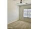 Bright bedroom with neutral carpet, a ceiling fan, and large window at 7925 S 52Nd Dr, Laveen, AZ 85339