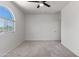 Bright bedroom with arched window and soft carpet at 7925 S 52Nd Dr, Laveen, AZ 85339
