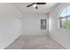Bedroom with a unique arched window and sliding closet doors at 7925 S 52Nd Dr, Laveen, AZ 85339