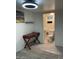 Inviting bedroom with an adjacent bathroom, complete with stylish tile flooring and modern ceiling light at 7925 S 52Nd Dr, Laveen, AZ 85339