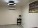 A simple, neutral bedroom featuring a mini split AC unit at 7925 S 52Nd Dr, Laveen, AZ 85339
