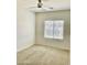 Bright bedroom with neutral carpet, a ceiling fan, and large window at 7925 S 52Nd Dr, Laveen, AZ 85339