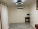Light bedroom featuring gray tile floors and a mini split AC unit at 7925 S 52Nd Dr, Laveen, AZ 85339