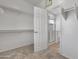 Walk-in closet leading to bright bathroom featuring glass-enclosed shower at 7925 S 52Nd Dr, Laveen, AZ 85339