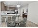 Cozy dining area with stylish lighting, connecting the kitchen and living spaces at 7925 S 52Nd Dr, Laveen, AZ 85339
