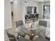 Stylish dining area with a glass-top table, perfect for Gathering meals and entertaining guests at 7925 S 52Nd Dr, Laveen, AZ 85339