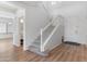 Welcoming foyer featuring a staircase and light hardwood floors leading to a bright, open living area with a cozy atmosphere at 7925 S 52Nd Dr, Laveen, AZ 85339