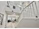 Bright entryway featuring a staircase with white railings and a view of the open floorplan living area at 7925 S 52Nd Dr, Laveen, AZ 85339