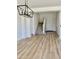 Open concept entrance, leading to stairs, with wood-look floors and stylish light fixture at 7925 S 52Nd Dr, Laveen, AZ 85339