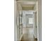 Hallway view towards living room with wood-look floors at 7925 S 52Nd Dr, Laveen, AZ 85339