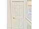 Hallway with a white paneled door and white banister at 7925 S 52Nd Dr, Laveen, AZ 85339