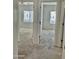 Carpeted hallway leading to two bedrooms with neutral paint at 7925 S 52Nd Dr, Laveen, AZ 85339