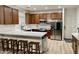 Well-equipped kitchen featuring stainless steel appliances, a breakfast bar, and rich wood cabinets at 7925 S 52Nd Dr, Laveen, AZ 85339