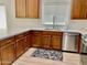 Well-lit kitchen with stainless steel appliances, including a dishwasher, and ample counter space at 7925 S 52Nd Dr, Laveen, AZ 85339