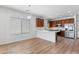 Open kitchen featuring stainless steel appliances, hardwood floors, and ample counter space at 7925 S 52Nd Dr, Laveen, AZ 85339