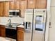 Modern kitchen featuring stainless steel appliances and natural wood cabinetry at 7925 S 52Nd Dr, Laveen, AZ 85339