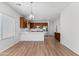 An open kitchen with stainless steel appliances, light counter tops and hardwood floors at 7925 S 52Nd Dr, Laveen, AZ 85339