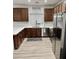 Modern kitchen with stainless steel appliances, wood cabinets, and ample counter space with natural light at 7925 S 52Nd Dr, Laveen, AZ 85339