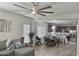 Open concept living space with large ceiling fan, seamlessly connecting the dining area and kitchen at 7925 S 52Nd Dr, Laveen, AZ 85339