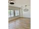 Bright living room featuring wood-look floors and modern light fixtures at 7925 S 52Nd Dr, Laveen, AZ 85339