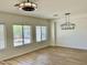 Bright living room with wood-look floors and natural light from the large windows at 7925 S 52Nd Dr, Laveen, AZ 85339