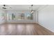 Expansive living area with hardwood floors, modern light fixtures, and large windows offering abundant natural light and space at 7925 S 52Nd Dr, Laveen, AZ 85339