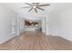 Open-concept living room featuring hardwood floors with view of the kitchen at 7925 S 52Nd Dr, Laveen, AZ 85339