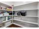 Organized pantry with white shelving and storage baskets at 7925 S 52Nd Dr, Laveen, AZ 85339