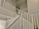Bright, carpeted staircase with white railings at 7925 S 52Nd Dr, Laveen, AZ 85339